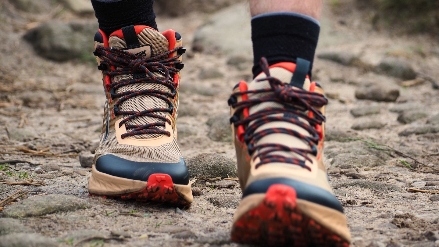 Closeup of LFTO testing walking rocky path wearing Altra Timp Hiker