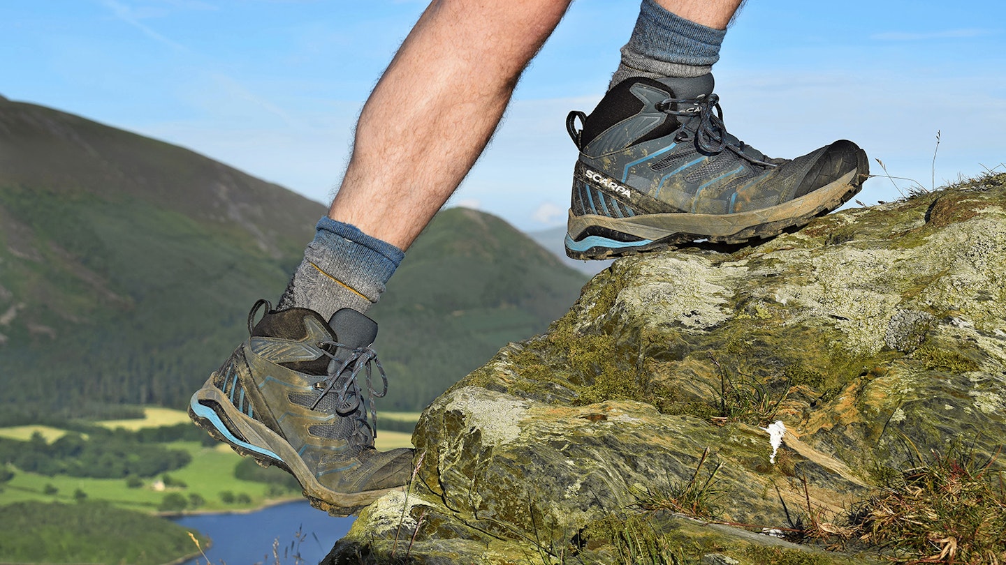 Hiker climbing wearing Scarpa Manta hiking boots