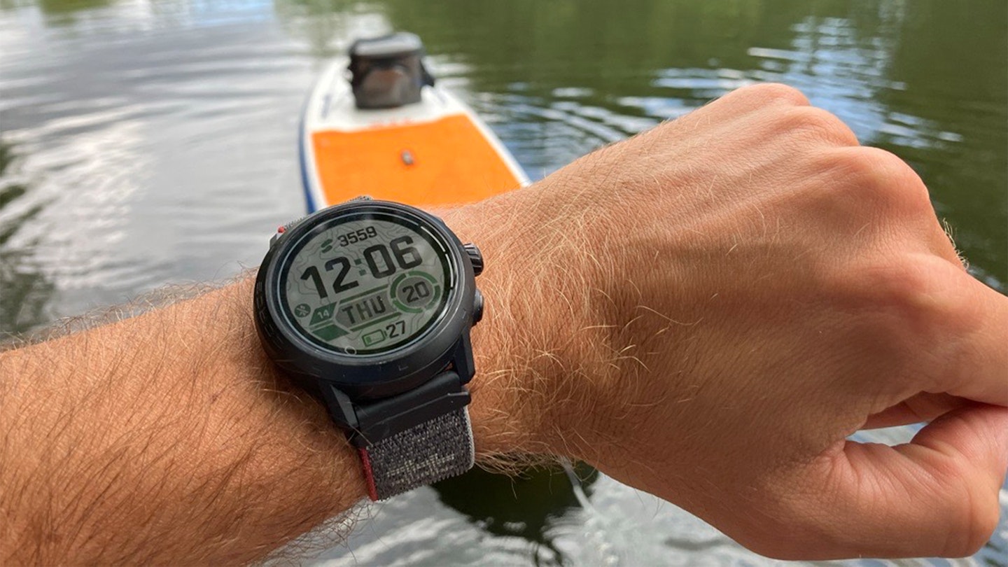 Gear Editor Oli Reed testing a coros GPS watch on a paddleboard