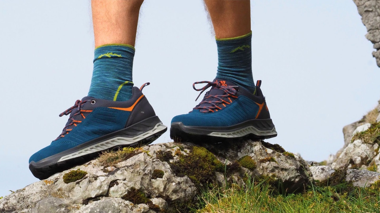 Closeup of hiker standing on a rock wearing Hanwag Blueridge Low ES shoes