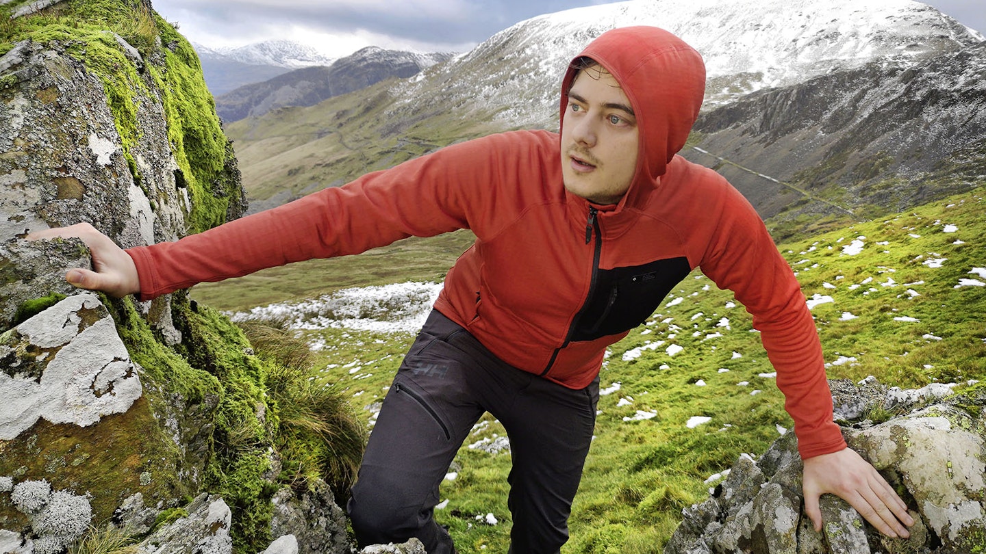 Hiker in the mountains wearing fleece jacket