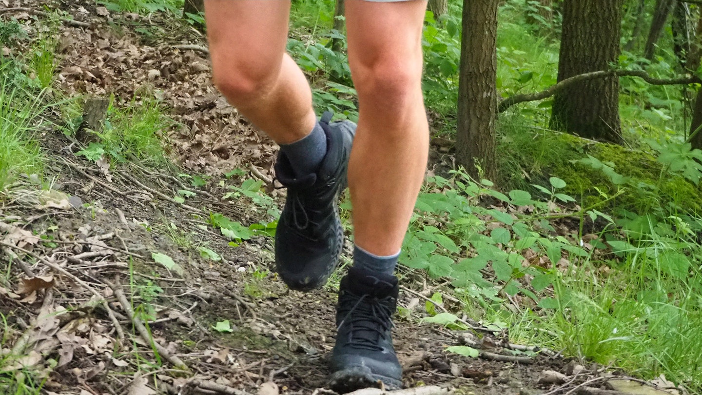 Hiker walking wearing Inov8 Roclite Mid GTX