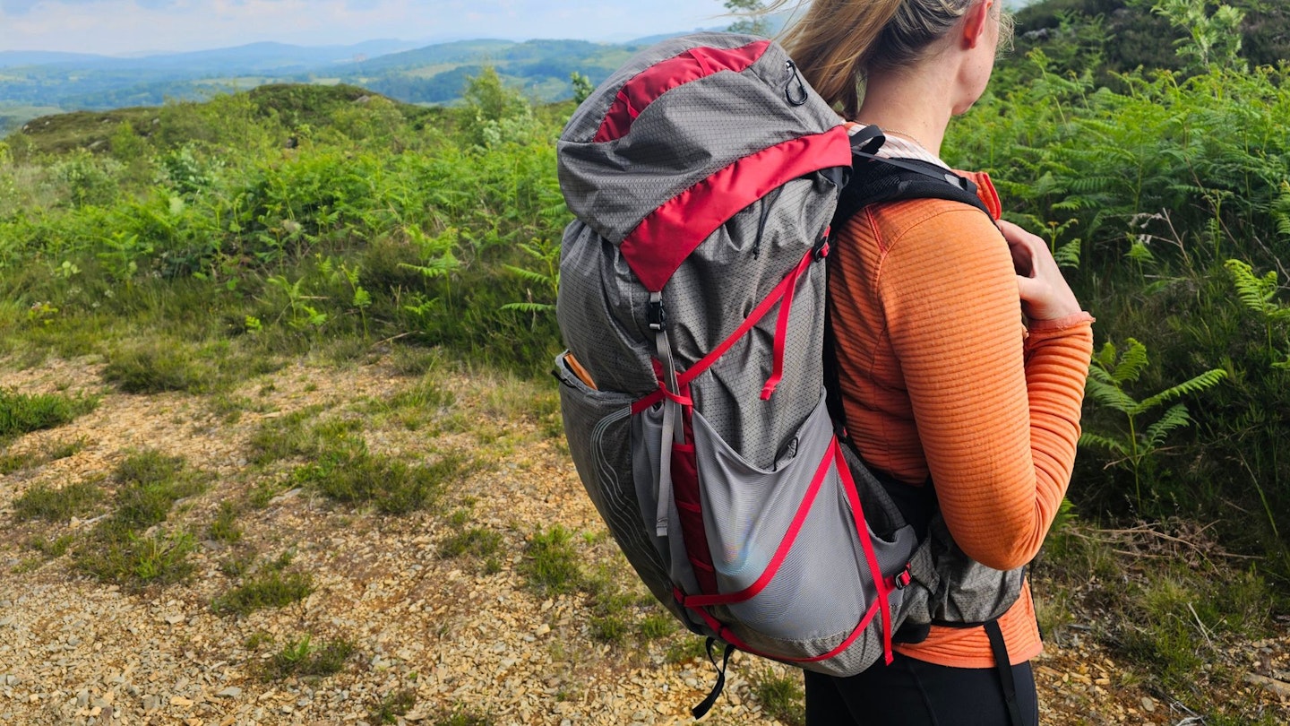 3/4 view of hiker wearing Osprey Eja Pro 55