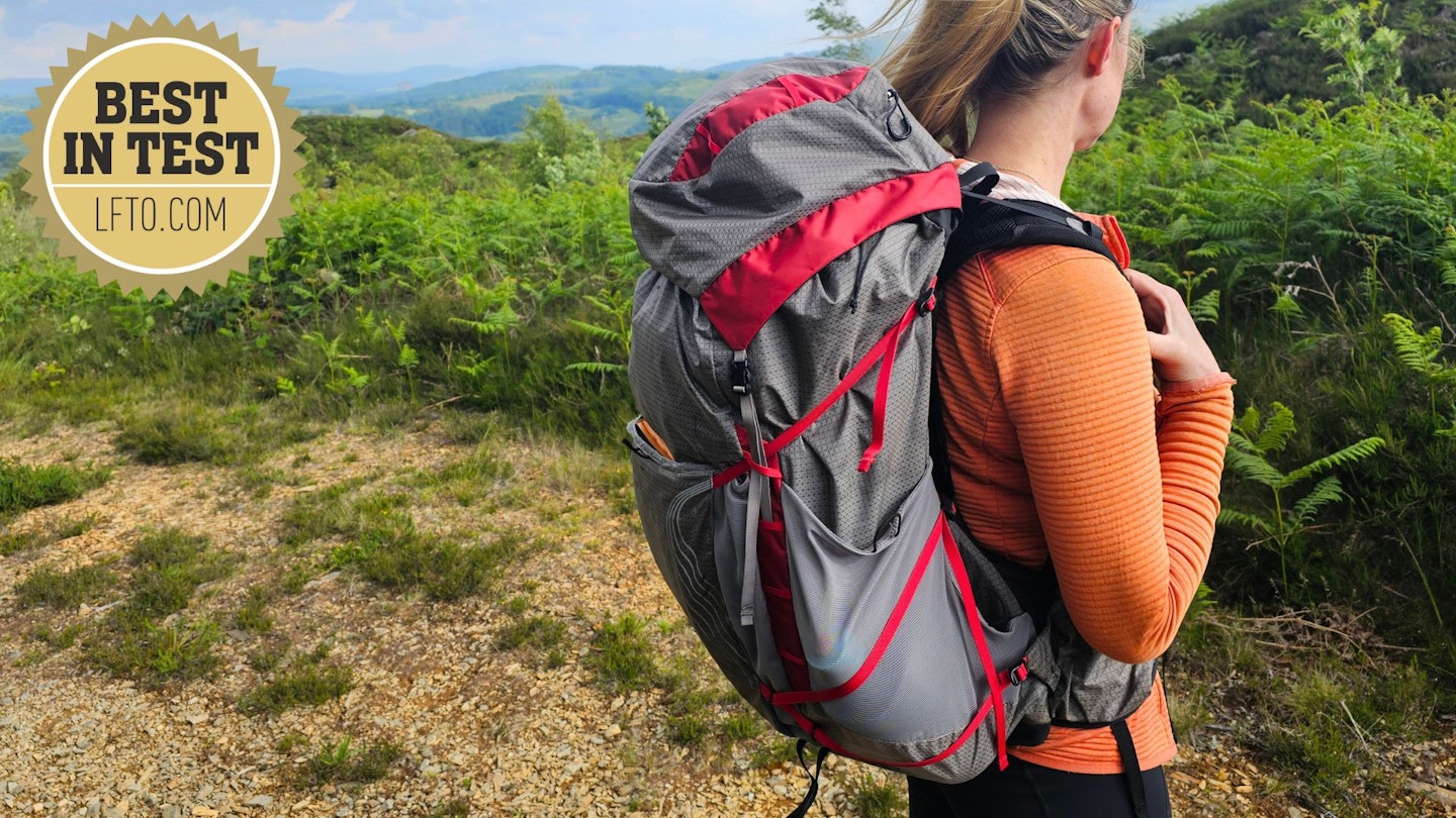 3/4 view of hiker wearing Osprey Eja Pro 55 with LFTO Best in Test award logo