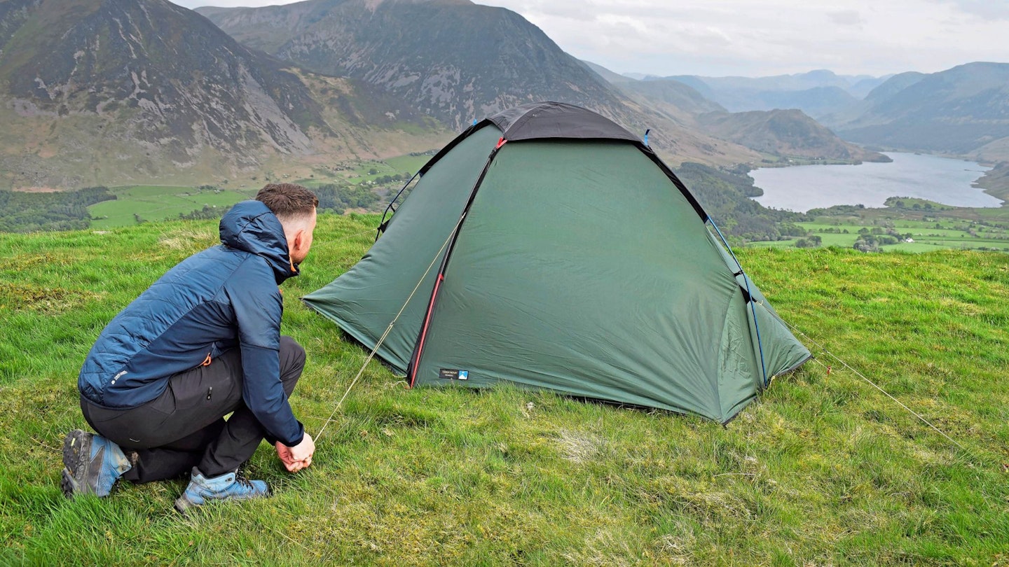 Hiker pitching Terra Nova Pioneer 2 tent